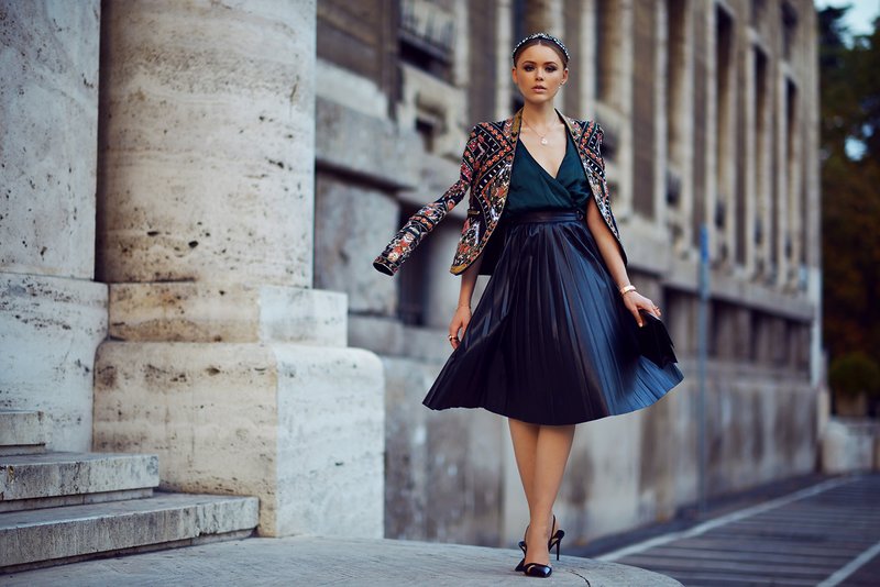 Stylish girl in a shiny midi skirt