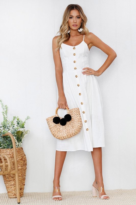 White dress with buttons along the entire length of the outfit