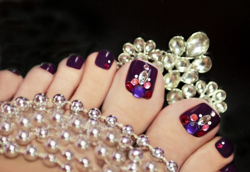 Purple pedicure with rhinestones