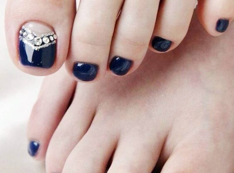 Dark blue pedicure with rhinestones