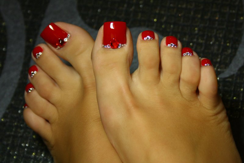 Red pedicure with rhinestones