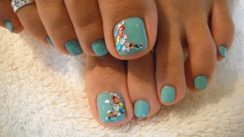 Pedicure with colored rhinestones