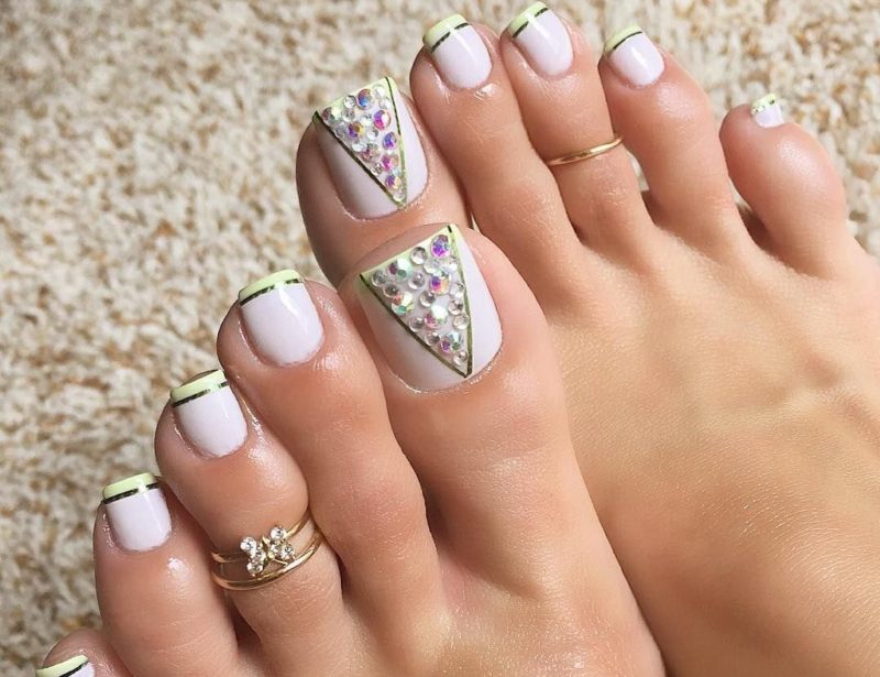 White pedicure with rhinestones and a jacket