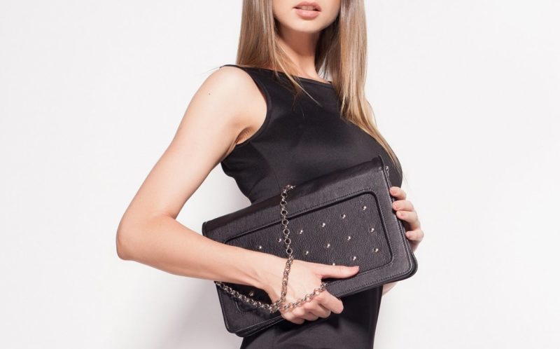 Black handbag under a sheath dress