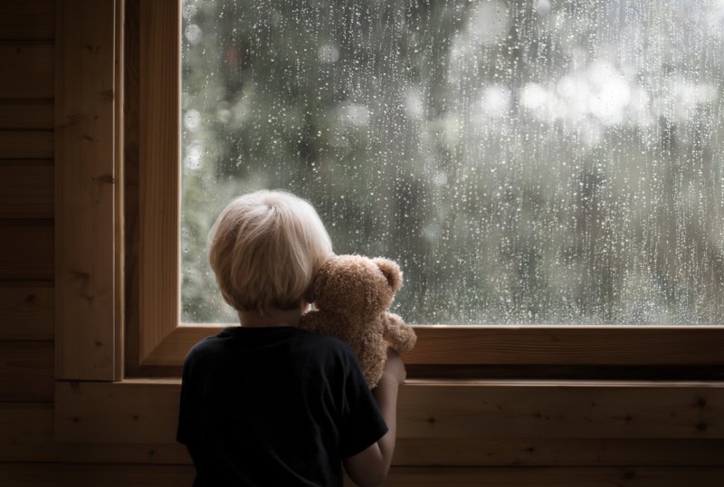 Boy looks out the window