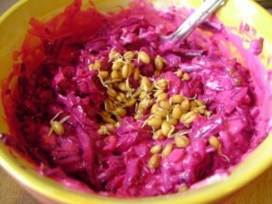 Beetroot salad with nuts, garlic and wheat seedlings