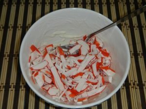 Salad with squid, crab sticks and red caviar