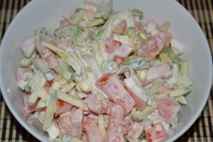 Fresh cucumber and tomato salad with egg and leek