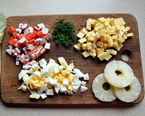 Salad with crab sticks and pineapple