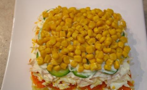 Delicious salad with chicken, fresh cucumber and corn