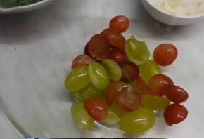 Tasty salad with grapes, meat and arugula in oriental style