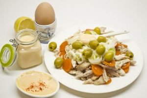 Holiday salad with chicken, feta cheese and hollandaise sauce