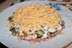 Salad with boiled sausage and green peas