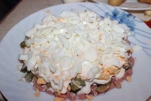 Salad with boiled sausage and green peas