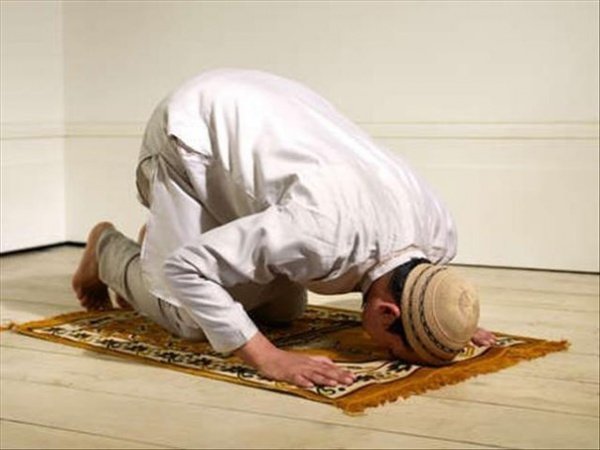 Muslim prayer kneeling and bow to the ground