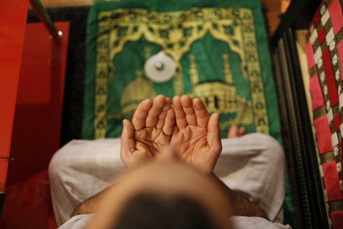 Muslim man reads the surah before going to bed