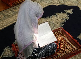 Muslim woman praying for house cleansing