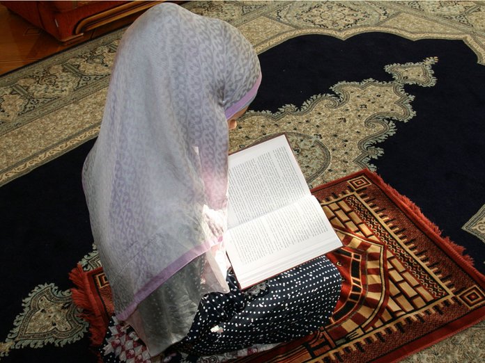 Muslim woman praying for house cleansing