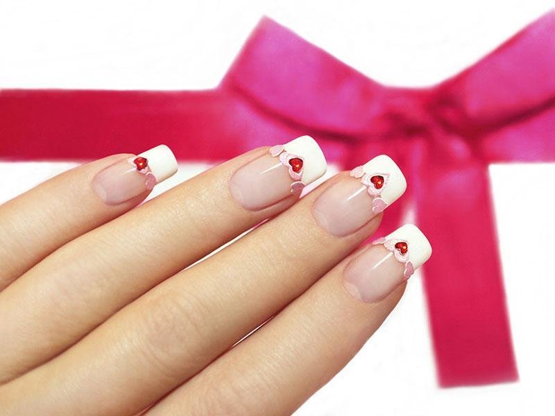 French manicure with rhinestones and a red heart