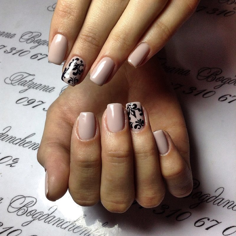 Pale pink nails with a black pattern