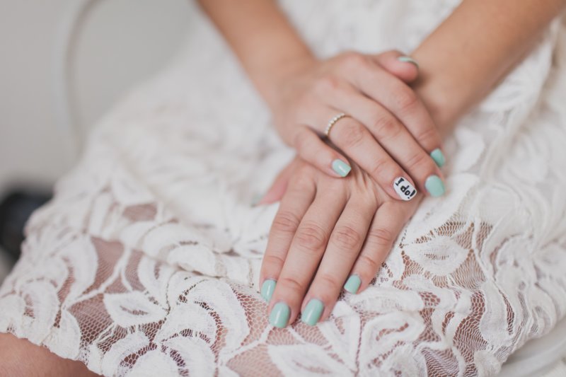 Turquoise manicure with the inscription