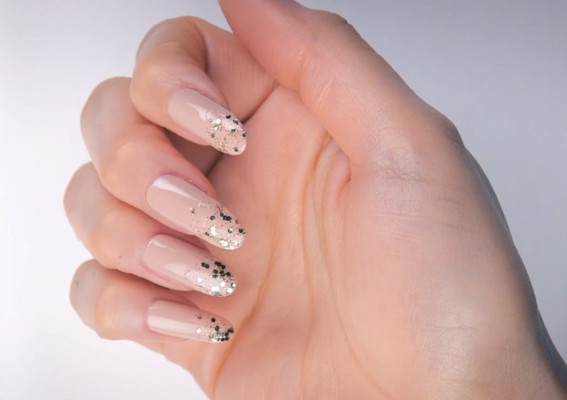 Nude manicure with camouflage and sequins