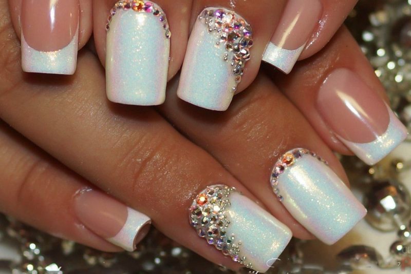 Mother of pearl white manicure with rhinestones and a jacket