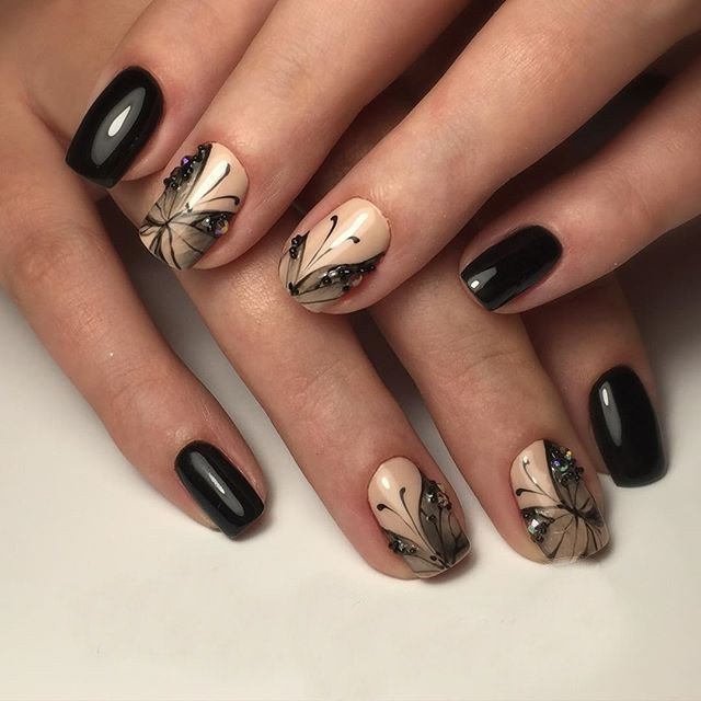 Beige with black manicure and butterfly pattern.