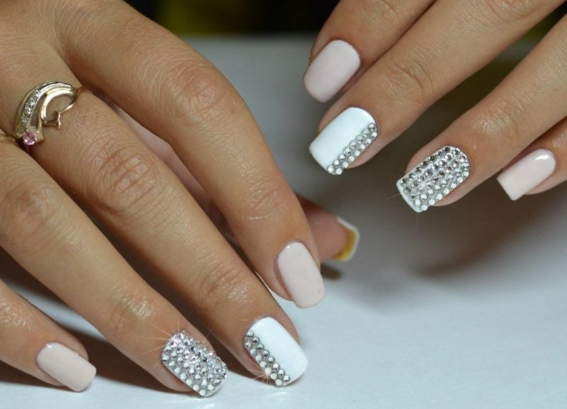 White-pink manicure with rhinestones