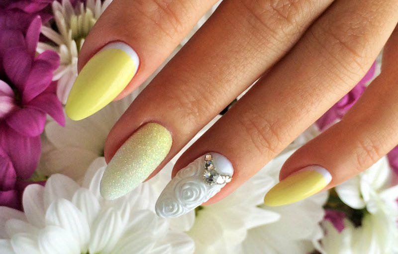 Yellow-white manicure with powder, rhinestones and a convex pattern