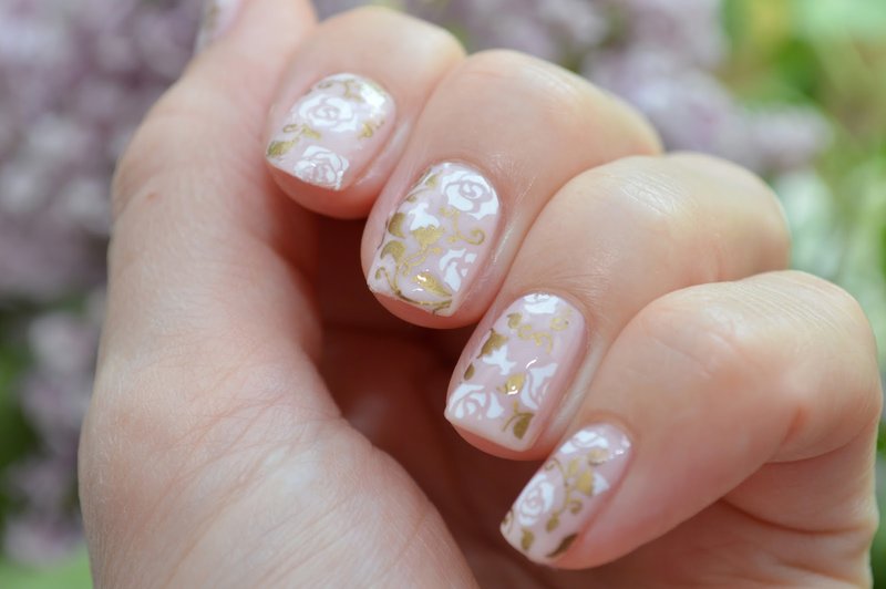 Nude manicure with floral slides.