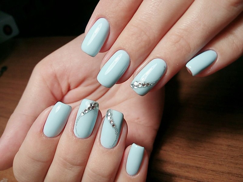 Sky blue nails with a wave of rhinestones