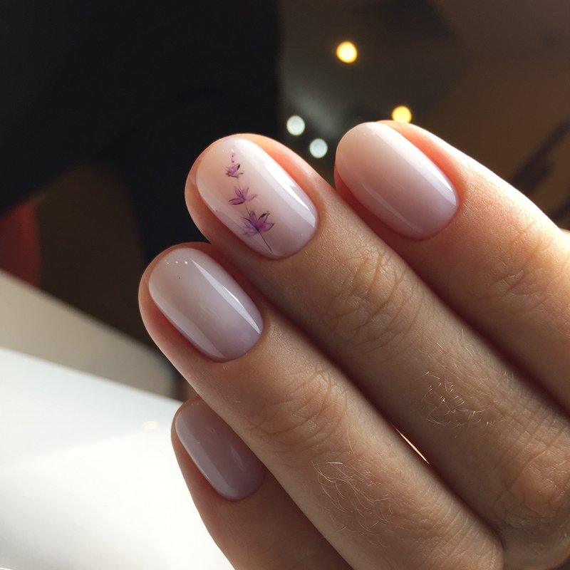 Nude manicure with a flower