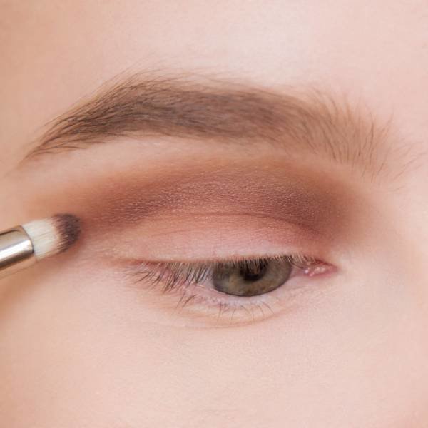 Applying dark shadows on a fixed eyelid and crease