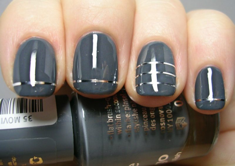 Gray manicure with silver ribbons.