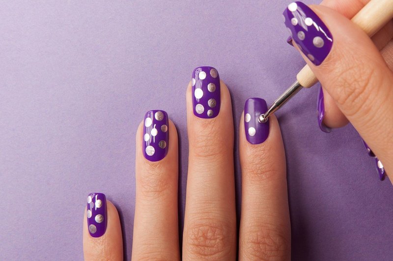 Purple manicure with silver dots.