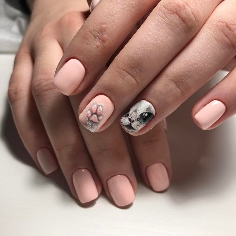 Pink and beige manicure with a cat pattern.