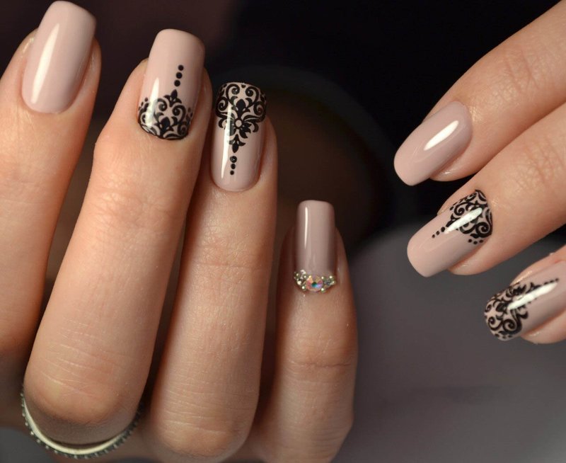 Beautiful nude manicure with vintage patterns.