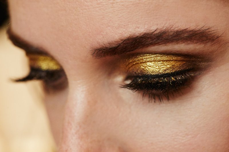 Fashionable make-up with golden shimmer