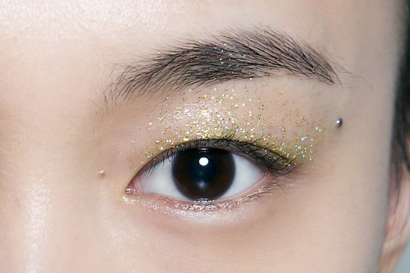 Golden eyelashes on the eyelids for an Asian-looking face