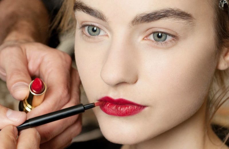 Apply a rich shade of lipstick to the lips