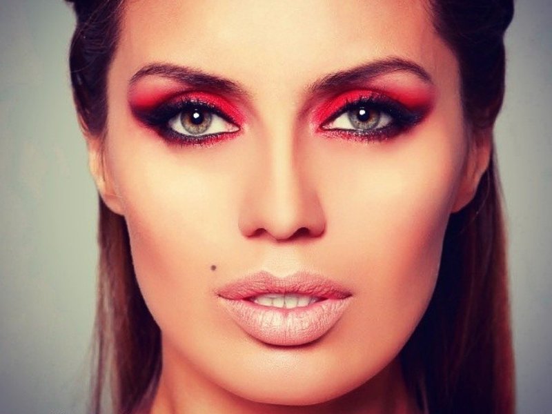 Bright makeup with red shadows.