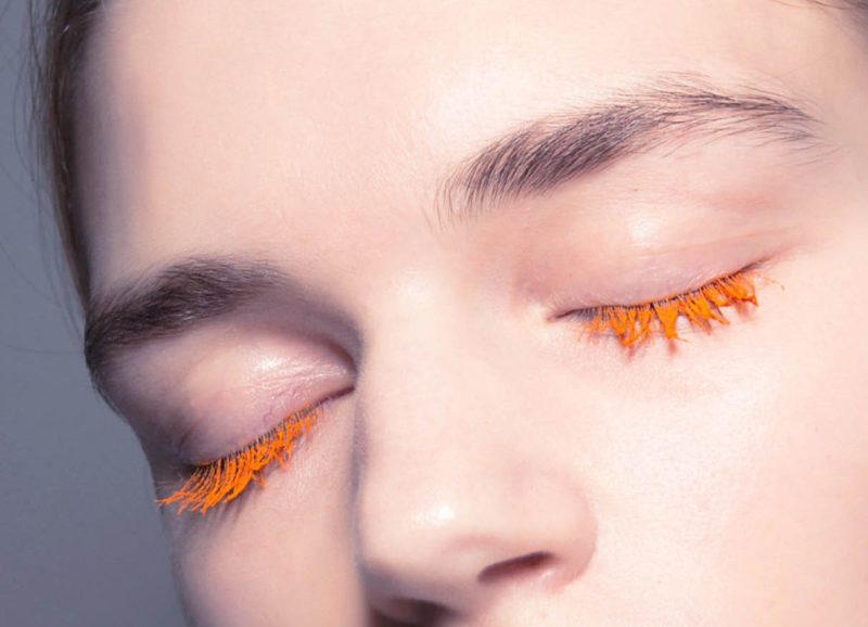 Colorless makeup with orange mascara