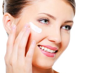 Applying Radevit cream on the face