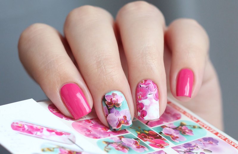 Colorful manicure with floral stickers.