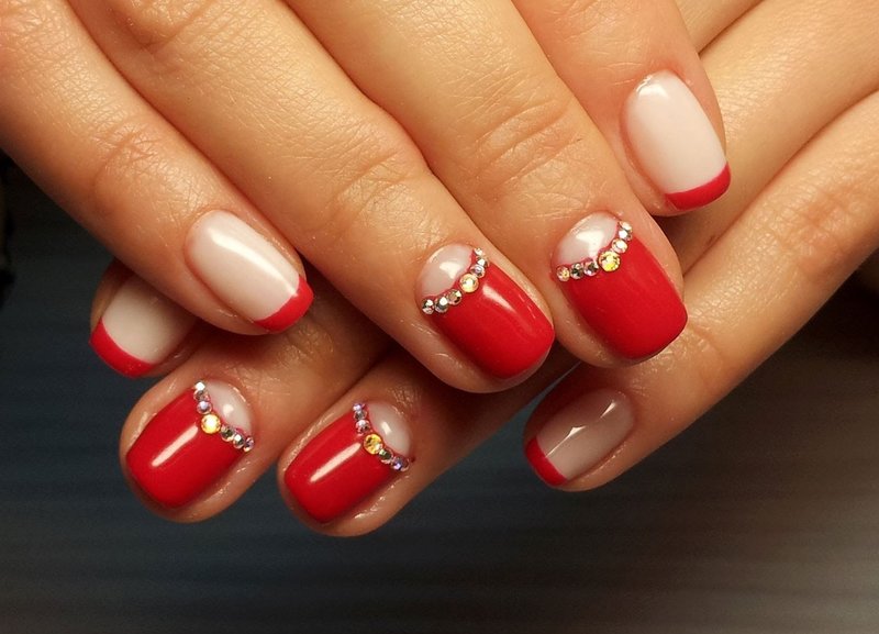 Red manicure with holes and rhinestones