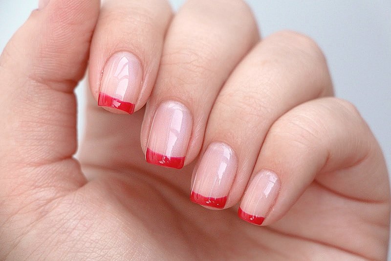 Nude manicure with a red jacket