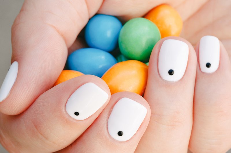 Black dot manicure on a white coating