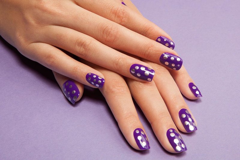 Purple manicure with silver dots.