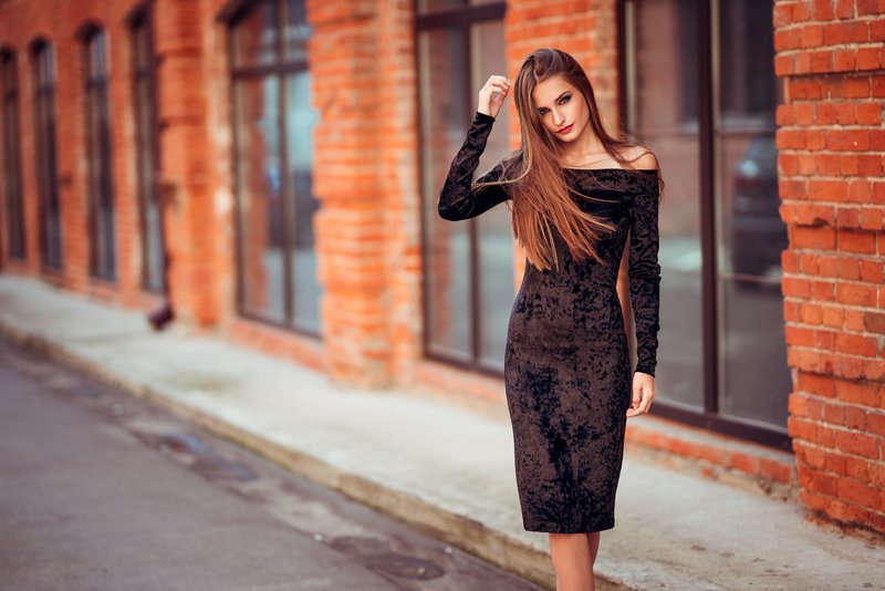 Girl in a cocktail velvet dress with sleeves